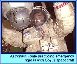 Astronaut Foale practicing emergency ingress with Soyuz spacecraft