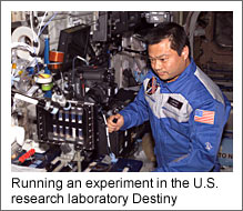 Running an experiment in the U.S. research laboratory Destiny (Courtesy of NASA)