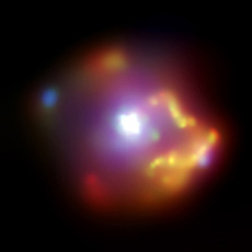 An image of the supernova remnant SNR 0540-69.3 in the Large Magellanic Cloud, observed by the Chandra X-ray Observatory. The white objects twinkling in the middle are high-energy particles. A cloud of high-temperature gas about 40 light years in diameter spreads around the remnant. (courtesy: NASA/CXC/SAO)
