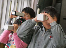 Children testing pinhole cameras they have made