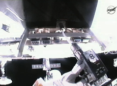 Cleaning a bolt hole with an improvised brush. (courtesy: NASA TV)