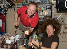 Astronauts Fincke and Magnus having Christmas cookies on December 25, 2008 (Courtesy of NASA) 
