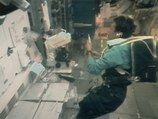 Astronaut Mamoru Mouri conducting an experiment (courtesy: JAXA/NASA)