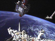 Astronauts Takao Doi and Winston Scott waiting for the SPARTAN satellite to approach (courtesy: NASA)